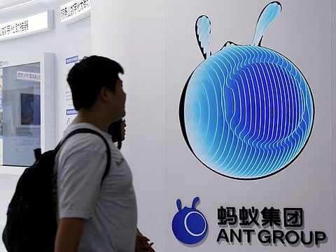 People walk past the Ant Group logo at its booth at the China International Fair for Trade in Services (CIFTIS) in Beijing, China.