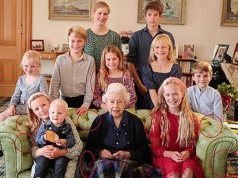A family portrait of Britain's late Queen Elizabeth II with some of her grandchildren and great grandchildren (back row, left to right) Lady Louise Mountbatten-Windsor, James, Earl of Wessex, (middle row, left to right) Lena Tindall, Prince George, Princess Charlotte, Isla Phillips, Prince Louis, (front row, left to right) Mia Tindall holding Lucas Tindall, and Savannah Phillips, taken at Balmoral Castle, Britain, in this undated handout image issued by Kensington Palace on April 21, 2023, with indications by Reuters of areas which appear to have been digitally altered by the source. 
