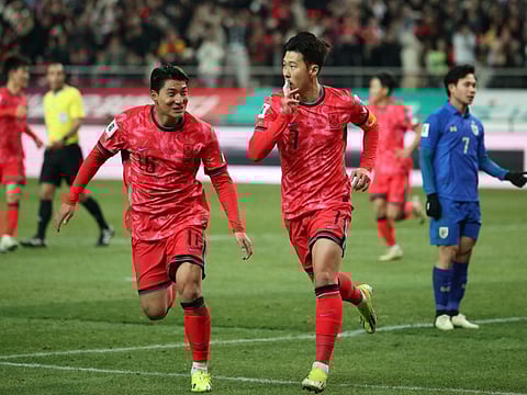 South Korea's Son Heung-min celebrates scoring their first goal with Joo Min-kyu during the AFC Qualifiers Group C match against Thailand at Seoul World Cup Stadium on Thursday.