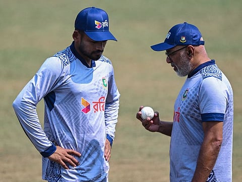Bangladesh's coach Chandika Hathurusingha and captain Najmul Hossain Shanto (left) talk during a practice session at the Zahur Ahmed Chowdhury Stadium in Chittagong on March 17.