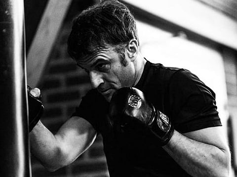 An official photo showing Emmanuel Macron hitting a punch bag.