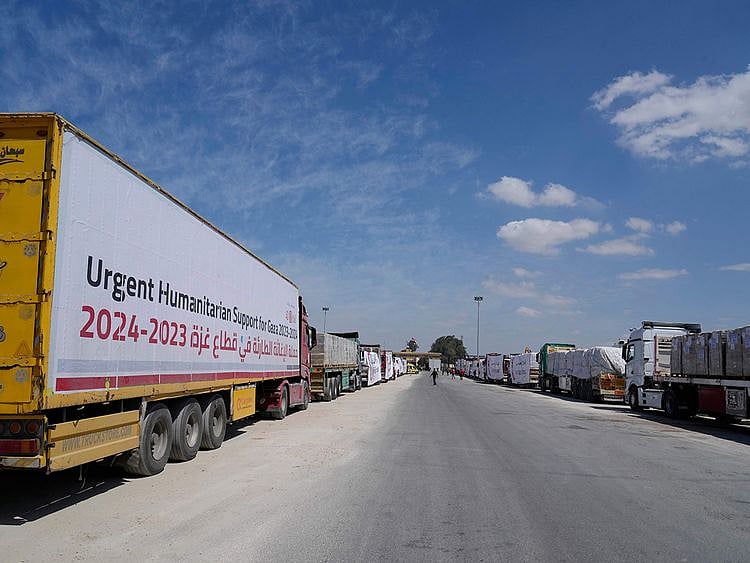 Aid trucks line up to cross the Rafah border crossing between Egypt and the Gaza Strip on March 23, 2024.  