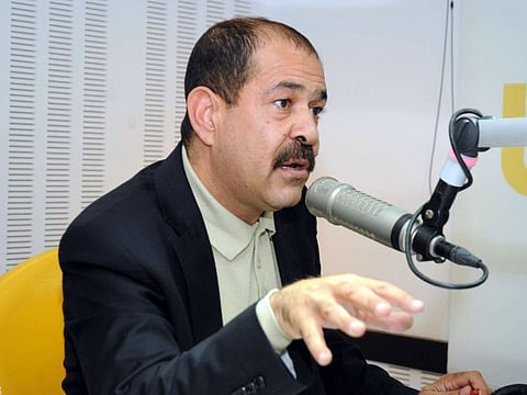 Tunisian lawyer and opposition leader Chokri Belaid speaks during a radio interview in Tunis on November 20, 2012.  