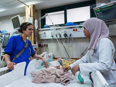 Pediatrician Tanya Haj-Hassan, left, examines wounded children at Al Aqsa Martyrs Hospital in Deir al-Balah, central Gaza.