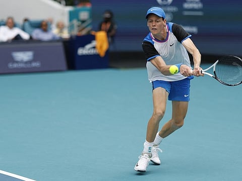 Jannik Sinner hits a backhand against Tomas Machac during the Miami Open at Hard Rock Stadium.