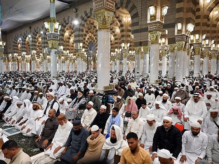 The faithful pray at Prophet's Mosque in Medina.  