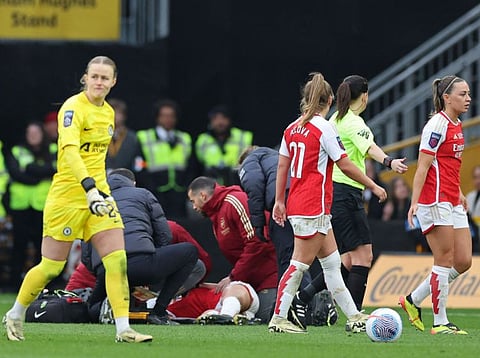 Players start to leave the pitch as Arsenal's Norwegian midfielder Frida Maanum receives medical attention after being taken ill during the English Women's League Cup final football match against Chelsea at Molineux in Wolverhampton on Sunday.