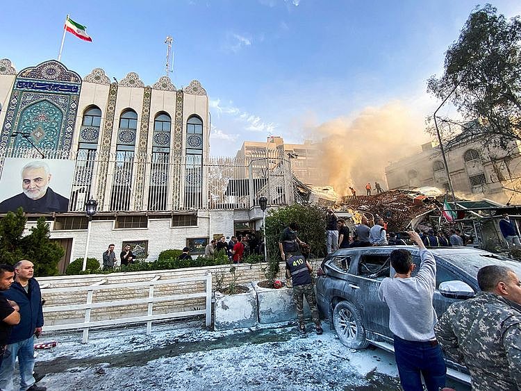  Smoke rises from the Iranian embassy annex building in Syria’s capital Monday.