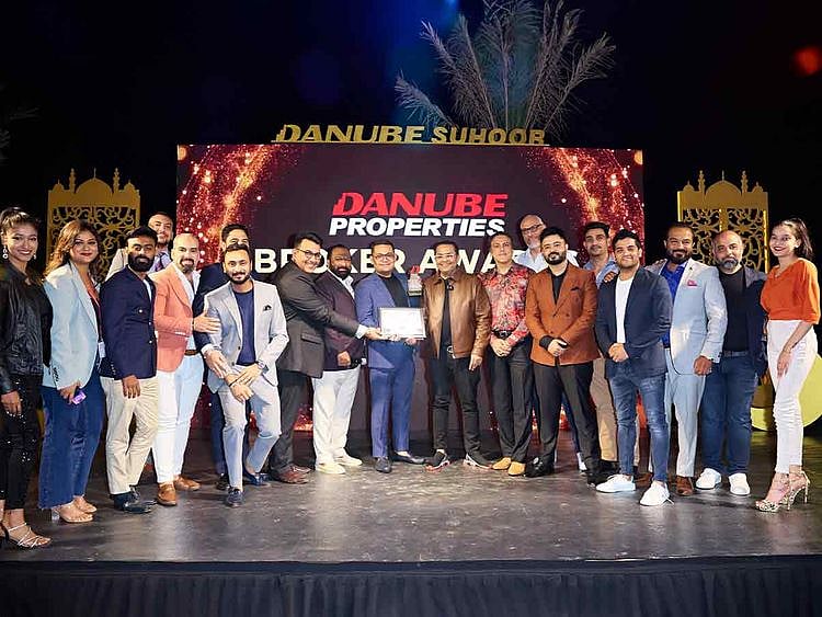 Team Homes 4 Life Real Estate receiving the 2nd ranked award from Danube Chairman Rizwan Sajan