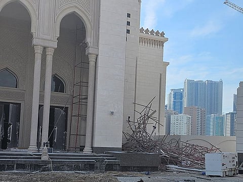 The collapsed scaffolding on the right of the mosque entrance 