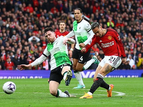 Liverpool's Andrew Robertson ateempts to block as Manchester United's Antony shoots at goal during a Premier League match at Old Trafford, Manchester on Sunday.