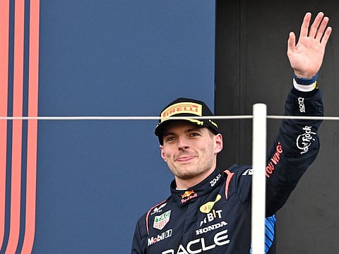 Red Bull Racing's Dutch driver Max Verstappen waves as he walks onto the podium after winning the Formula One Japanese Grand Prix race at the Suzuka circuit in Suzuka, Mie prefecture on April 7, 2024. 
