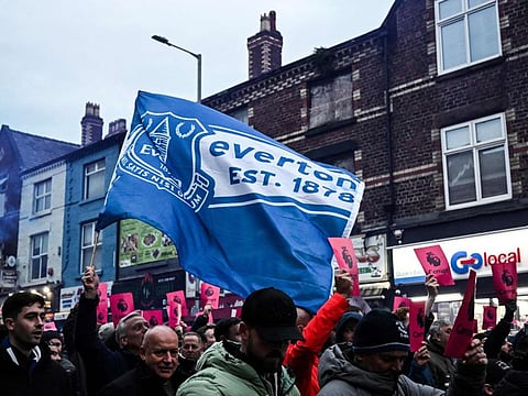 Everton's supporters protest over the club 10-point punishment for breaching financial regulation in the streets, prior to the English Premier League football match against Manchester United at Goodison Park in Liverpool on November 26, 2023.