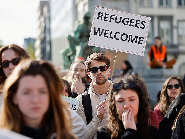 Human rights activists protests outside the European Parliament ahead of a vote by lawmakers on the EU's Pact on Asylum and Migration, in Brussels, on April 10, 2024.