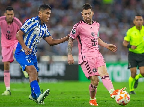 Inter Miami's forward Lionel Messi (right) and Monterrey's midfielder Luis Romo fight for the ball during the Concacaf Champions Cup quarter-final second-leg football match at the BBVA Stadium on Wednesday.