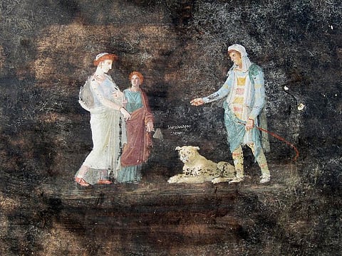 Frescoes depicting mythological characters Helen and Paris according to a Greek inscription placed between the two figures in a banqueting room with black walls part of the ongoing excavations in the block 10 of Regio IX, in Pompeii, near Naples. 