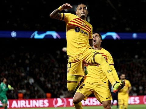 Barcelona's Raphinha leaps in the air as he celebrates after scoring the second goal in the Uefa Champions League quarter-finals first leg against PSG on Wednesday.