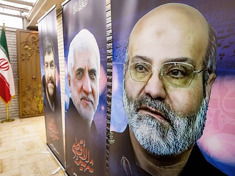 Posters depicting victims of an air strike on the consular annex of the Iranian embassy's headquarters in Damascus are displayed during a memorial service for them on the premises in the Syrian capital on April 3, 2024.  