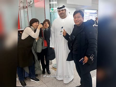 Al Habsi with the three travellers after finding their passports, seen here in an image posted on the X account of DXB
