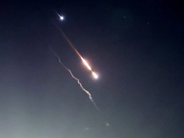 Objects are seen in the sky above Jerusalem after Iran launched drones and missiles towards Israel on April 14, 2024. 