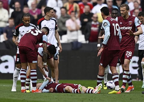 West Ham United's George Earthy looks in pain after sustaining an injury during a Premier League match against Fulham at London Stadium.
