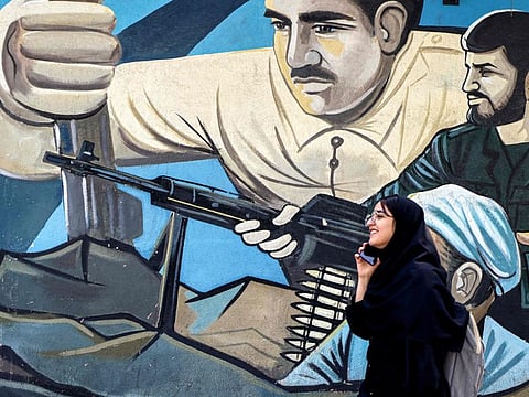 An anti-Israeli mural depicting fighters with assault rifles along a wall in Palestine Square in Tehran on April 14, 2024.  