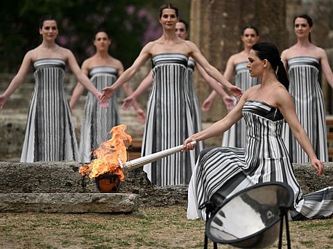 Greek actress Mary Mina, playing the role of the High Priestess, lights the torch during the flame lighting ceremony for the Paris 2024 Olympics Games at the ancient temple of Hera on the Olympia archeological site, birthplace of the ancient Olympics in southern Greece, on Tuesday.