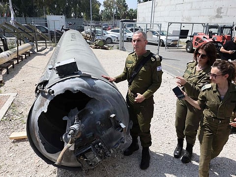 Members of the Israeli military show an Iranian ballistic missile which fell in Israel on the weekend, during a media tour at the Julis military base near the southern Israeli city of Kiryat Malachi on April 16, 2024.  