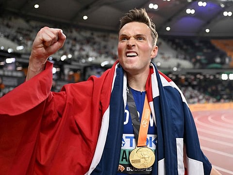 Norway's Karsten Warholm celebrates with his gold medal after winning the men's 400m hurdles final during the World Athletics Championships at the National Athletics Centre in Budapest on August 23, 2023.