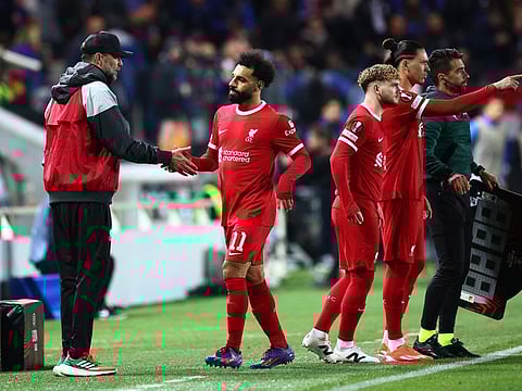 Liverpool's Mohamed Salah shakes hands with manager Juergen Klopp after being substituted against Atalanta.