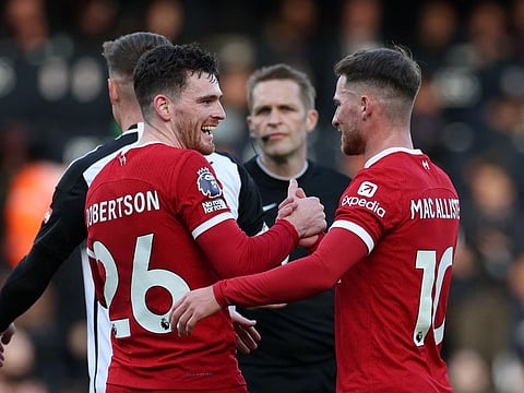 Liverpool's Andrew Robertson celebrates with Alexis Mac Allister after the Premier League match against Fulham on Sunday.