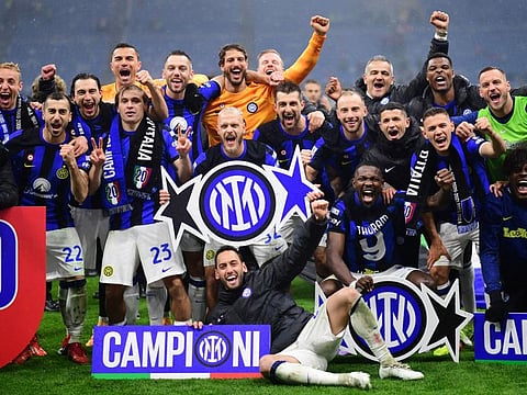 Inter Milan players celebrate winning their 20th Serie A title after the Serie A match against AC Milan at San Siro, Milan on Monday.