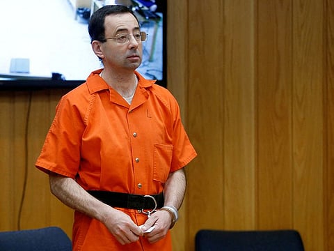 File photo: Larry Nassar, a former team USA Gymnastics doctor who pleaded guilty in November 2017 to sexual assault charges, stands in court during his sentencing hearing in the Eaton County Court in Charlotte, Michigan, February 5, 2018.  