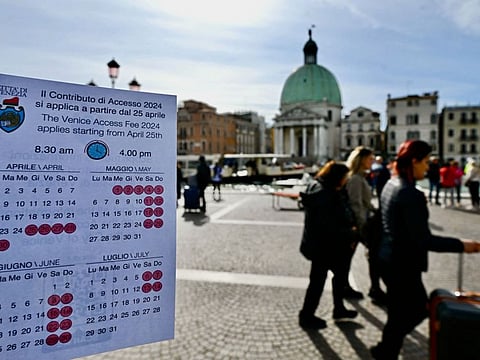 A calendar of the paying days to visit Venice is put up in front of Santa Lucia train station in Venice.  