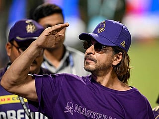 Bollywood actor and co-owner of Kolkata Knight Riders' team Shah Rukh Khan (R) greets fans after their win at the Indian Premier League (IPL) Twenty20 cricket match between Kolkata Knight Riders and Delhi Capitals at the Eden Gardens in Kolkata on April 29, 2024