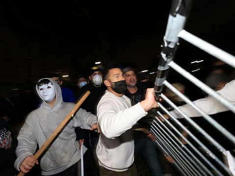 Counter-protesters try to remove barricades at a pro-Palestinian encampment on the University of California, Los Angeles (UCLA) campus in Los Angeles, California, on May 1, 2024.  