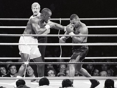 This photo taken on February 11, 1990 shows US world heavyweight champion Mike Tyson (right) fighting against US challenger James Douglas during their world heavyweight boxing title bout at the Tokyo Dome stadium in Tokyo.