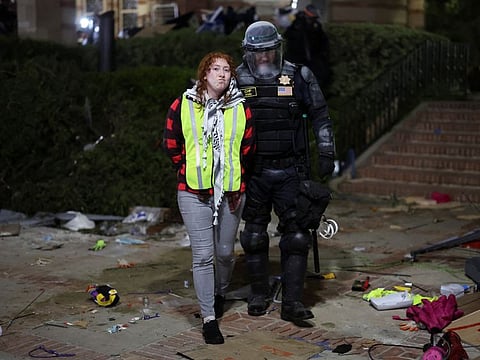 A law enforcement officer detains a protester at the University of California Los Angeles (UCLA), during a pro-Palestinian protest in Los Angeles, US, May 2, 2024.  