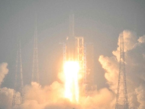 A Long March 5 rocket, carrying the Chang'e-6 mission lunar probe, lifts off as it rains at the Wenchang Space Launch Centre in southern China's Hainan Province on May 3, 2024. 