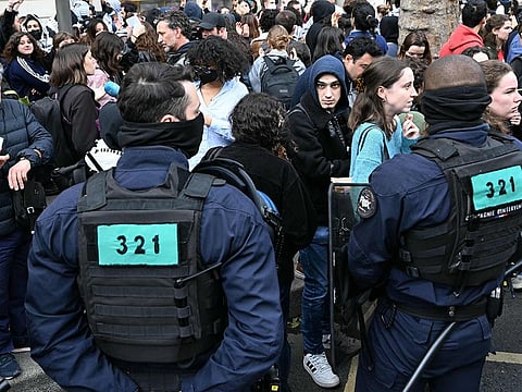 Protesters, supporters and journalists are surrounded by French gendarmes after the evacuation of a pro-Gaza sit-in in the entrance hall of the Institute of Political Studies (Sciences Po Paris) in Paris on May 3, 2024.  