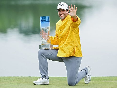 Spain's Adrian Otaegui celebrates with the trophy after winning the China Open Golf tournament in Shenzhen on Sunday.