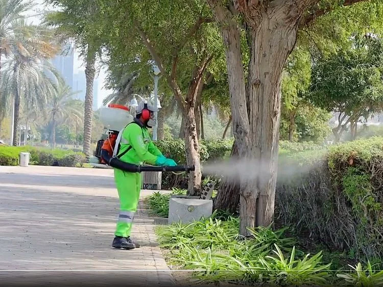 Still from video of an Abu Dhabi Public Health Centre team member using control measures against mosquitoes, flies and other pests