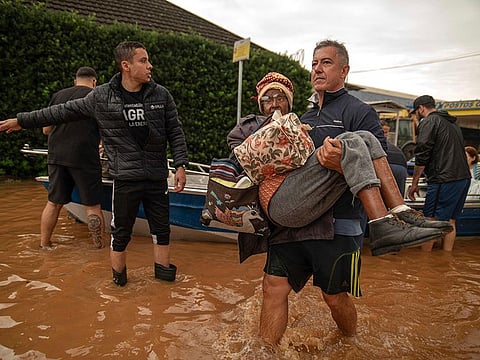 People are evacuated from a flooded area in Porto Alegre, Rio Grande do Sul State, Brazil, on May 4, 2024