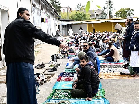Muslims gather on the private parking lot of a construction site for prayer in Monfalcone, on April 26, 2024.  