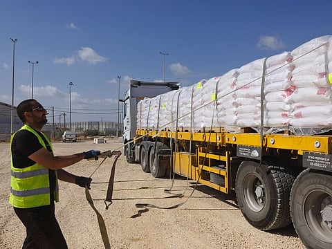 A driver secures a humanitarian aid truck before it crosses the Israel-Gaza border, in Erez, southern Israel.
