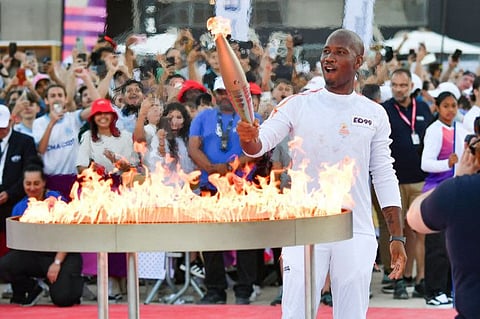 French Ivorian former football player Didier Drogba lights the Olympic and Paralympic Torch Relays cauldron, designed by Mathieu Lehanneur with the Olympic Torch as part of the Olympic and Paralympic Torch Relays at the Stade Velodrome, ahead of the Paris 2024 Olympic and Paralympic Games, in Marseille, southeastern France, on Thursday.