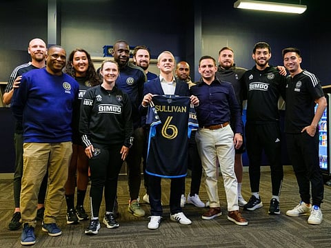 Philadelphia Union midfielder Cavan Sullivan poses for a photograph with technical staff after a press conference announcing his professional contract at Subaru Park.