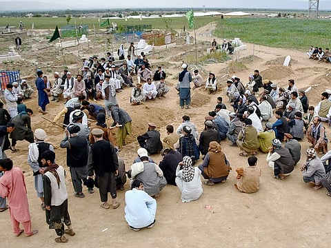 Relatives attend a burial ceremony of victims who lost their lives following flash floods after heavy rainfall at a village in Baghlan-e-Markazi district of Baghlan province  in Afghanistan on May 11, 2024. 