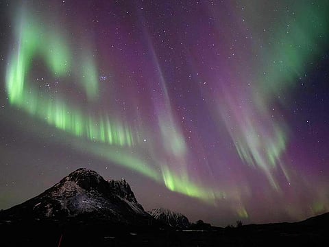 This picture shows northern lights (Aurora Borealis) over the mountain at Utakleiv on March 3, 2024 in Lofoten Islands. A huge solar storm is heading for Earth, supercharging auroras and bringing possible disruptions to satellites and power grids as early as the evening of May 10, 2024, US officials say. 