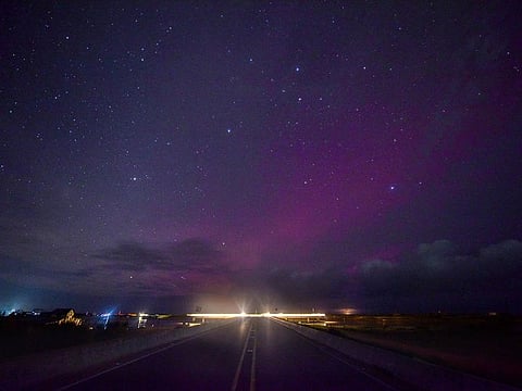 The Aurora Australis, also known as the Southern Lights, is faintly seen over the Laguna Garzon Bridge between the Uruguayan southeastern departments of Maldonado and Rocha, near the seaside resort of Jose Ignacio.